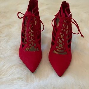 Red lace pumps